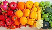 Verschiedene Gemüse- und Obstarten in Regenbogenfarben angeordnet